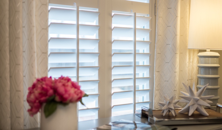 Plantation shutters by flowers in Bluff City